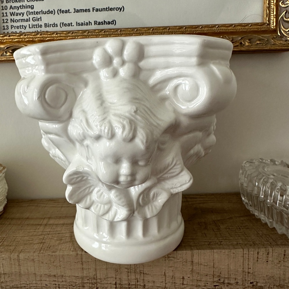 a white angel candle holder
